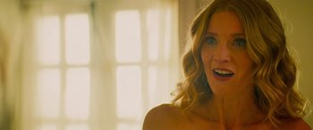 Movie still from “Savage Salvation” (2022), directed by Randall Emmett – A woman's face in front of a window; Close Up shot, Over the shoulder angle