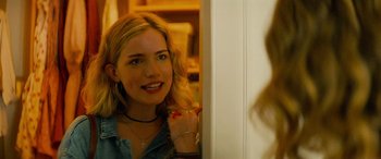 Movie still from “Savage Salvation” (2022), directed by Randall Emmett – A beautiful young lady standing in front of a bathroom mirror; Close Up shot, Over the shoulder angle