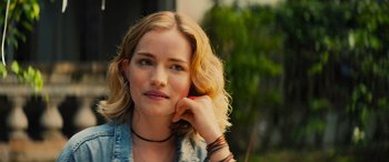 Movie still from “Savage Salvation” (2022), directed by Randall Emmett – A beautiful blond haired woman holding a cell phone to her ear; Close Up shot, Over the shoulder angle