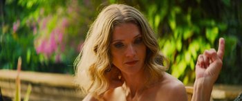 Movie still from “Savage Salvation” (2022), directed by Randall Emmett – A person wearing a bra; Close Up shot, Over the shoulder angle