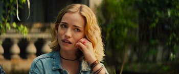 Movie still from “Savage Salvation” (2022), directed by Randall Emmett – A person holding a cell phone to their ear; Close Up shot, Over the shoulder angle