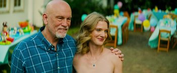 Movie still from “Savage Salvation” (2022), directed by Randall Emmett – A man and a woman pose for a picture; Medium shot, Low angle