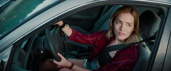 Movie still from “Savage Salvation” (2022), directed by Randall Emmett – A woman sitting in the drivers seat of a car; Close Up shot, High angle