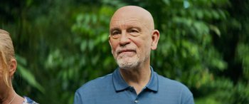 Movie still from “Savage Salvation” (2022), directed by Randall Emmett – An older man with a shaved head is looking at the camera; Close Up shot, Low angle