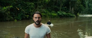 Movie still from “Savage Salvation” (2022), directed by Randall Emmett – A man standing in a body of water; Medium shot, Over the shoulder angle