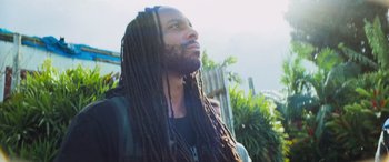 Movie still from “Savage Salvation” (2022), directed by Randall Emmett – A person with dreadlocks looking up; Close Up shot, Low angle