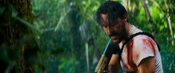 Movie still from “Savage Salvation” (2022), directed by Randall Emmett – A man holding a gun in his hands; Close Up shot, Low angle