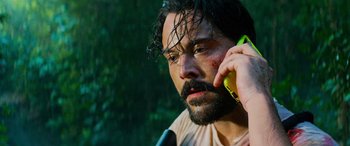Movie still from “Savage Salvation” (2022), directed by Randall Emmett – A man with a beard is talking on a cell phone; Close Up shot, Over the shoulder angle