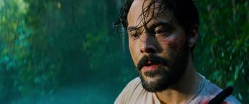 Movie still from “Savage Salvation” (2022), directed by Randall Emmett – A person with wet hair and a beard; Close Up shot, Low angle