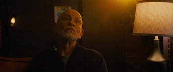 Movie still from “Savage Salvation” (2022), directed by Randall Emmett – An older man is looking up in the dark; Close Up shot, Low angle