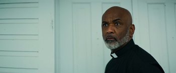 Movie still from “Savage Salvation” (2022), directed by Randall Emmett – A man with a gray beard wearing a black shirt; Close Up shot, Low angle