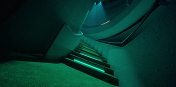 Movie still from “Savage x Fenty Show Vol. 3” (2021), directed by Alex Rudzinski – A green lit up staircase in a building; Extreme Wide shot, Low angle