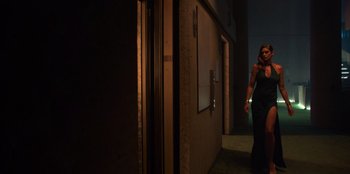 Movie still from “Savage x Fenty Show Vol. 3” (2021), directed by Alex Rudzinski – A person standing in a dark room next to a building; Wide shot, Low angle