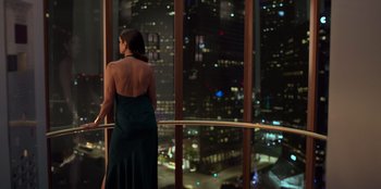 Movie still from “Savage x Fenty Show Vol. 3” (2021), directed by Alex Rudzinski – A woman standing in front of a window at night; Wide shot, High angle