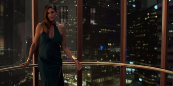 Movie still from “Savage x Fenty Show Vol. 3” (2021), directed by Alex Rudzinski – A woman in a green dress standing in front of a window; Medium shot, Low angle