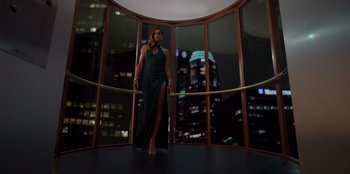 Movie still from “Savage x Fenty Show Vol. 3” (2021), directed by Alex Rudzinski – A woman in a dress standing next to a window; Wide shot, Low angle