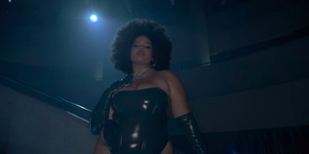 Movie still from “Savage x Fenty Show Vol. 3” (2021), directed by Alex Rudzinski – A woman in a black leather outfit and gloves; Medium shot, Low angle