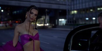 Movie still from “Savage x Fenty Show Vol. 3” (2021), directed by Alex Rudzinski – A woman in a purple bikini is standing in the street; Medium shot, Low angle