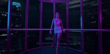 Movie still from “Savage x Fenty Show Vol. 3” (2021), directed by Alex Rudzinski – A woman standing in front of a window at night; Wide shot, Low angle