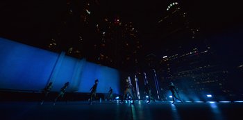 Movie still from “Savage x Fenty Show Vol. 3” (2021), directed by Alex Rudzinski – A group of people standing on top of a stage; Extreme Wide shot, Low angle