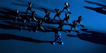 Movie still from “Savage x Fenty Show Vol. 3” (2021), directed by Alex Rudzinski – A group of people standing on top of each other in the dark; Extreme Wide shot, Overhead angle
