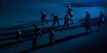 Movie still from “Savage x Fenty Show Vol. 3” (2021), directed by Alex Rudzinski – A group of people standing in the middle of a field; Extreme Wide shot, High angle