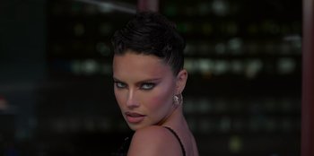 Movie still from “Savage x Fenty Show Vol. 3” (2021), directed by Alex Rudzinski – A woman with short black hair wearing a black dress; Close Up shot, High angle