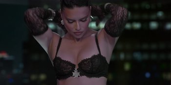 Movie still from “Savage x Fenty Show Vol. 3” (2021), directed by Alex Rudzinski – A woman in a black bra and black gloves; Close Up shot, High angle