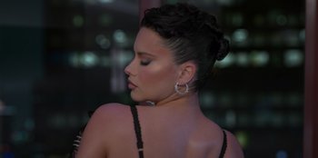 Movie still from “Savage x Fenty Show Vol. 3” (2021), directed by Alex Rudzinski – A beautiful woman with short black hair wearing a black bra; Close Up shot, Low angle