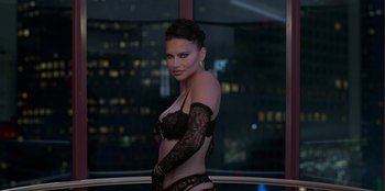 Movie still from “Savage x Fenty Show Vol. 3” (2021), directed by Alex Rudzinski – A woman in a black lingerie standing in front of a window; Medium shot, High angle