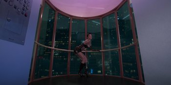 Movie still from “Savage x Fenty Show Vol. 3” (2021), directed by Alex Rudzinski – A woman standing in front of a window in a building; Wide shot, Low angle