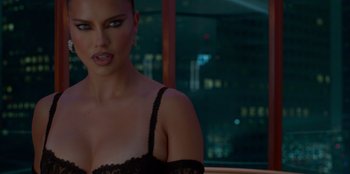 Movie still from “Savage x Fenty Show Vol. 3” (2021), directed by Alex Rudzinski – A woman in a black bra is standing in front of a window; Close Up shot, Over the shoulder angle