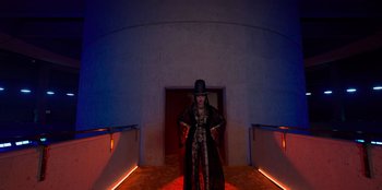 Movie still from “Savage x Fenty Show Vol. 3” (2021), directed by Alex Rudzinski – A woman in a long black coat and a hat; Wide shot, Low angle