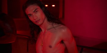 Movie still from “Savage x Fenty Show Vol. 3” (2021), directed by Alex Rudzinski – A man with long black hair is posing for the camera; Close Up shot, High angle
