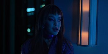 Movie still from “Savage x Fenty Show Vol. 3” (2021), directed by Alex Rudzinski – A woman with blue eyes and purple lipstick; Close Up shot, Low angle