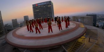 Movie still from “Savage x Fenty Show Vol. 3” (2021), directed by Alex Rudzinski – A group of people standing on top of a building; Extreme Wide shot, High angle
