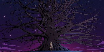 Movie still from “Savage x Fenty Show Vol. 4” (2022), directed by Alex Rudzinski – A woman standing in front of a large tree at night; Extreme Wide shot, Low angle