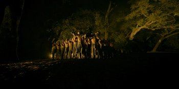 Movie still from “Savage x Fenty Show Vol. 4” (2022), directed by Alex Rudzinski – A group of people standing in the dark; Extreme Wide shot, Low angle