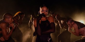 Movie still from “Savage x Fenty Show Vol. 4” (2022), directed by Alex Rudzinski – A group of people standing in the dark; Medium shot, Low angle