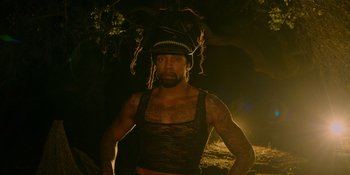 Movie still from “Savage x Fenty Show Vol. 4” (2022), directed by Alex Rudzinski – A man with dreadlocks and a hat on his head; Medium shot, Low angle