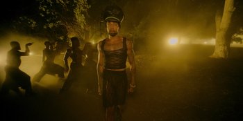 Movie still from “Savage x Fenty Show Vol. 4” (2022), directed by Alex Rudzinski – A man wearing a helmet is walking in the dark; Medium shot, Low angle