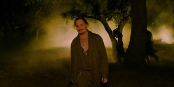 Movie still from “Savage x Fenty Show Vol. 4” (2022), directed by Alex Rudzinski – A man in a brown robe standing in front of a tree; Medium shot, Over the shoulder angle