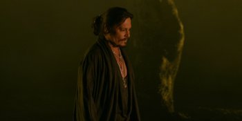 Movie still from “Savage x Fenty Show Vol. 4” (2022), directed by Alex Rudzinski – A man in a black robe standing in the dark; Close Up shot, Over the shoulder angle