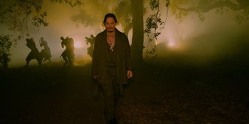 Movie still from “Savage x Fenty Show Vol. 4” (2022), directed by Alex Rudzinski – A man walking through a foggy forest at night; Wide shot, High angle