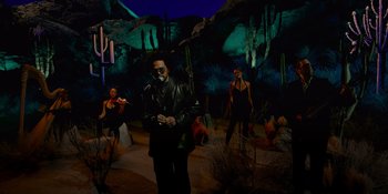 Movie still from “Savage x Fenty Show Vol. 4” (2022), directed by Alex Rudzinski – A man standing in front of a group of women; Wide shot, Low angle