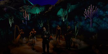 Movie still from “Savage x Fenty Show Vol. 4” (2022), directed by Alex Rudzinski – A group of men standing in a desert at night; Wide shot, Low angle