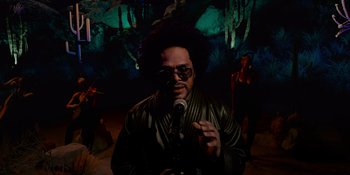 Movie still from “Savage x Fenty Show Vol. 4” (2022), directed by Alex Rudzinski – A man with a microphone in front of a group of people; Medium shot, Low angle