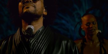 Movie still from “Savage x Fenty Show Vol. 4” (2022), directed by Alex Rudzinski – A person with a microphone; Close Up shot, Low angle