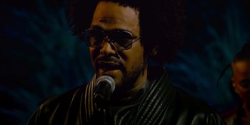 Movie still from “Savage x Fenty Show Vol. 4” (2022), directed by Alex Rudzinski – A person with a microphone; Close Up shot, Low angle