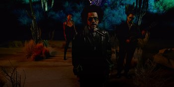 Movie still from “Savage x Fenty Show Vol. 4” (2022), directed by Alex Rudzinski – A group of people standing next to each other in a room; Wide shot, Low angle